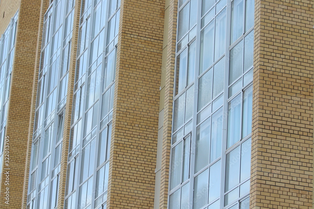 Plastic windows in a modern tiled brick high-rise house. Plastic windows in a modern tiled brick high-rise house.