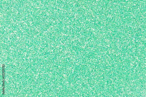 Perfect holographic glitter texture for project design work, background in light green tone.