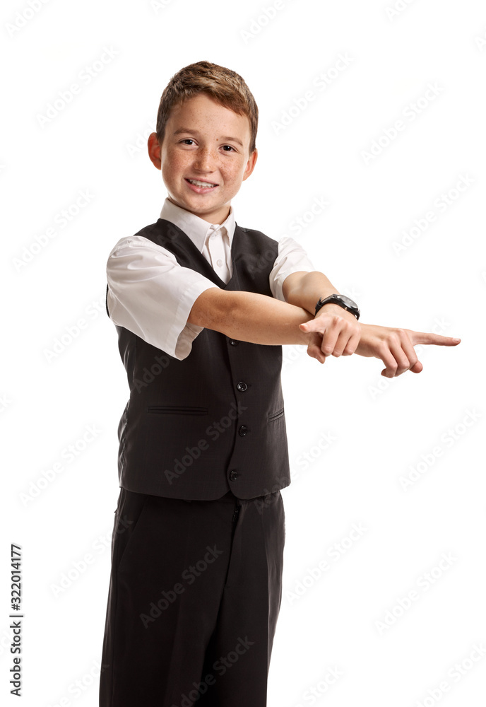 Young confident boy in school uniform pointing away on white background Young confident boy in school uniform pointing away on white background