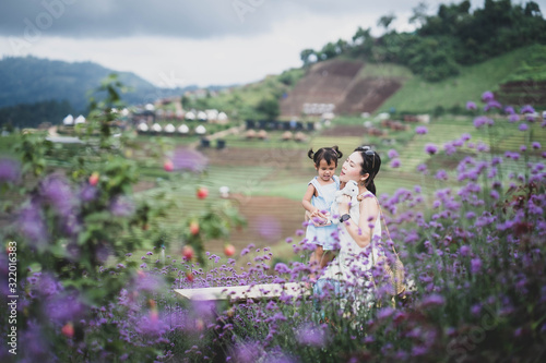 Mother and daughter at verbena flower field.