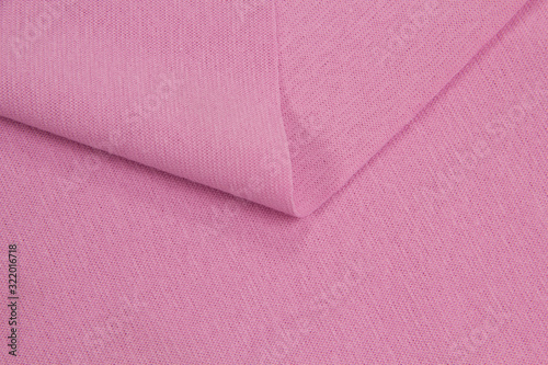 Fabric cotton fold, top view. Pink textile 