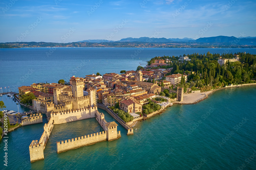 Unique view. Aerial photography, the city of Sirmione on Lake Garda north of Italy. In the background is the Alps. Resort place. Aerial view. Sirmione Castle,