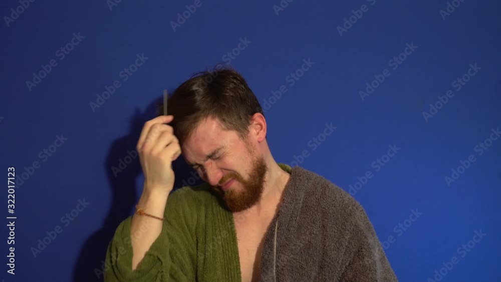 The guy in the Bathrobe after a shower, combs her hair The guy in the Bathrobe after a shower, combs her hair