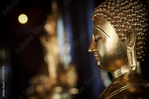 Selective focus  close-up shots of of the Buddha images with soft light and layout design for a beautiful religious background. © Ping198