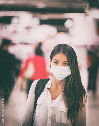 Coronavirus travel Asian woman wearing surgical face mask for virus transmission spreading prevention. Chinese girl on commute in airport flight crowded train station or public space.