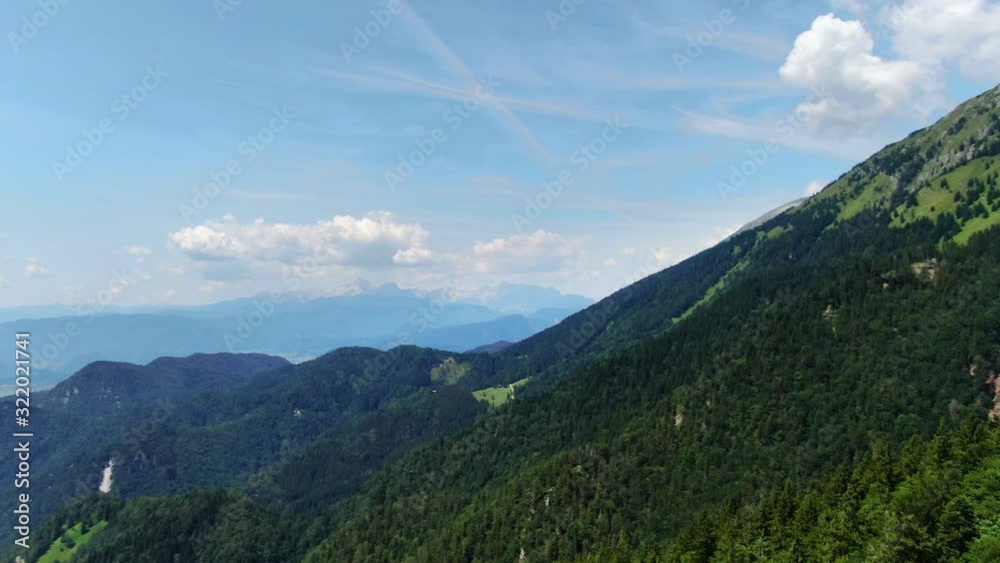 Aerial pan right above forest high on mountain prevala, slovenia