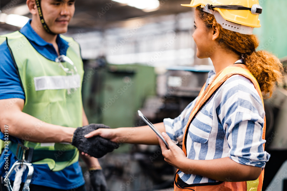 Industrial Engineers in Hard Hats.Work at the Heavy Industry Manufacturing Factory.industrial worker indoors in factory.Staff working in an industrial factory. Industrial Engineers in Hard Hats.Work at the Heavy Industry Manufacturing Factory.industrial worker indoors in factory.Staff working in an industrial factory.