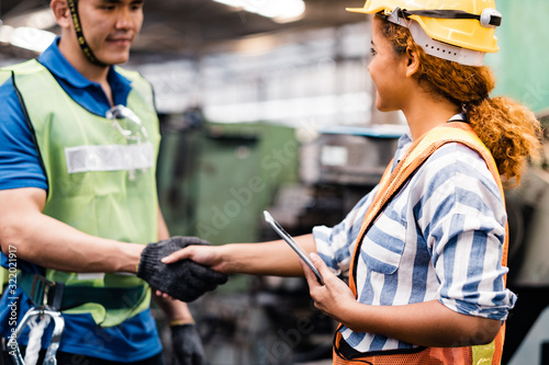 Industrial Engineers in Hard Hats.Work at the Heavy Industry Manufacturing Factory.industrial worker indoors in factory.Staff working in an industrial factory.