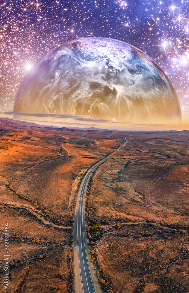 Alien planet rising over desert landscape with vivid starry sky and ...