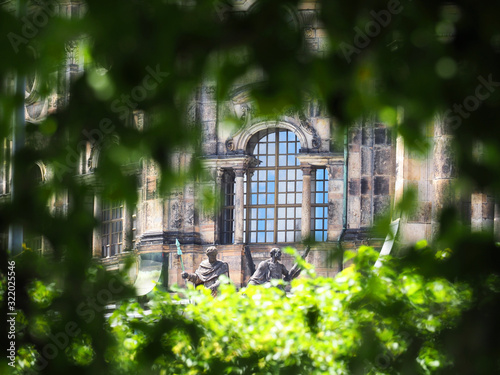 Altstadt, Bruhl Terrace park, view of the istoric building and sculptures through tree branches, Dresden, Germany photo