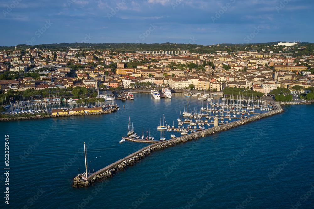 Aerial view of the city center of Desenzano del Garda, Italy. The main lighthouse of the city, boat parking in the city center