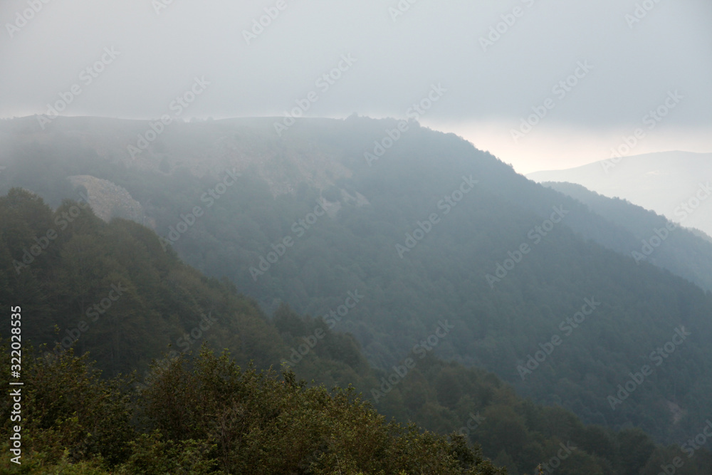 Flowing clouds closeup on mountains