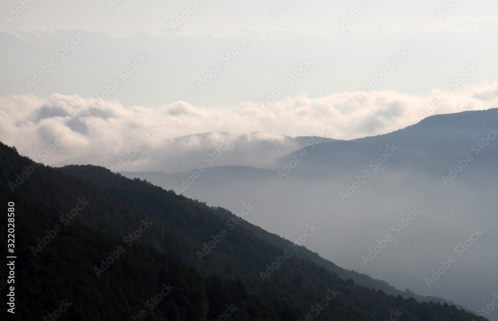 Flowing clouds closeup on mountains