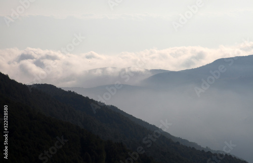 Flowing clouds closeup on mountains © Kybele