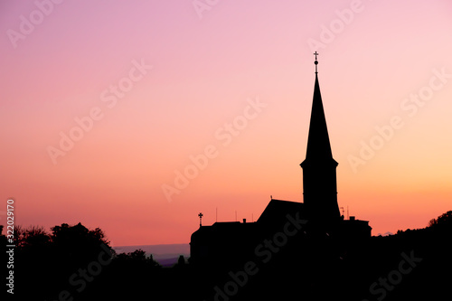 Silhouette view of parish Orthodox church in the evening at Gumpoldskirchen, a famous place for its wine and Heurigers as a great hillside vineyards. © Sitthipong