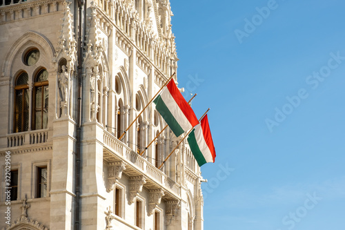 Hungarian flags on the Hungarian Parliament Building or Parliament of Budapest, a landmark and popular tourist destination in Budapest, Hungary photo