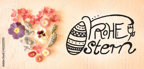 Notalgic Wooden Background With German Calligraphy Frohe Ostern Means Happy Easter. Colorful Spring Flower Blossoms Heart