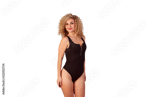 Portraitof curly beautiful woman dressed in black body suite isolated on the white background.