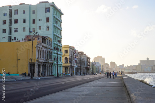 Malecon promenade with cars against the background of old buildings in Havana, Cuba