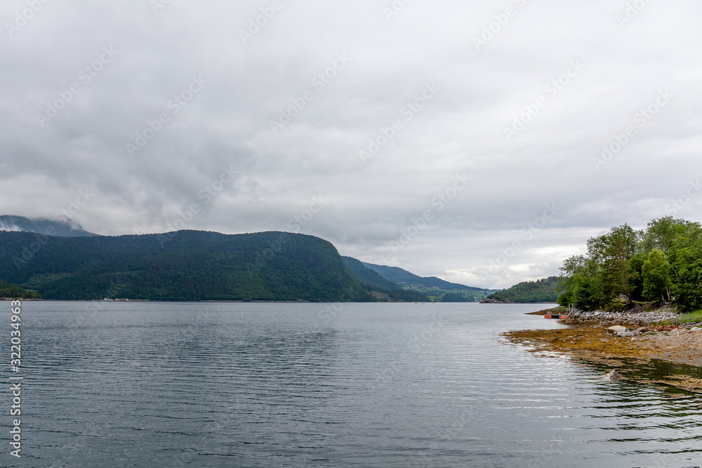 End of fjord. Beautiful Norwegian landscape. view of the fjords. Norway ideal fjord reflection in clear water In cloudy weather. selective focus