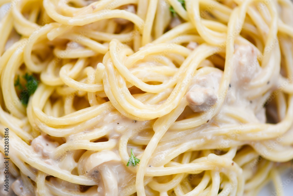 Spaghetti italian pasta served on plate with parsley in the restaurant italian food and menu concept - spaghetti carbonara , close up Spaghetti italian pasta served on plate with parsley in the restaurant italian food and menu concept - spaghetti carbonara , close up