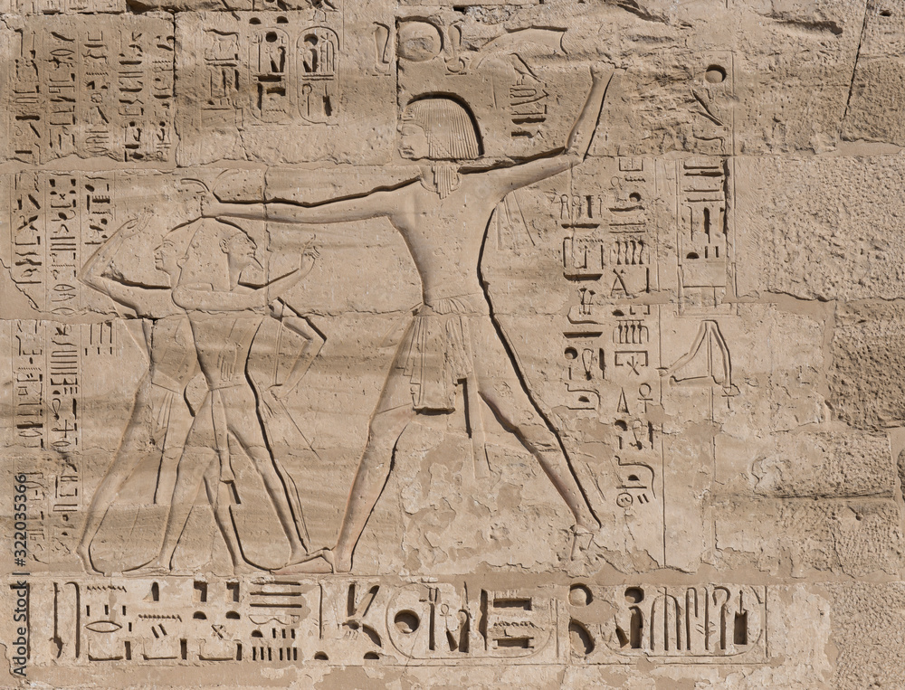 Hieroglyphic carvings on an ancient egyptian temple wall Hieroglyphic carvings on an ancient egyptian temple wall