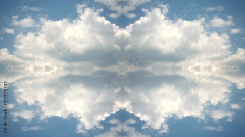Creative 4k time lapse video of moving clouds with reflection and mirror effect as in a kaleidoscope. Beautiful mirrored pattern of fast moving clouds in a blue summer sky.