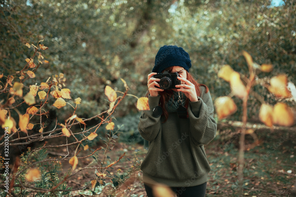 Young woman taking photos in the forest with an old camera Stock Photo ...