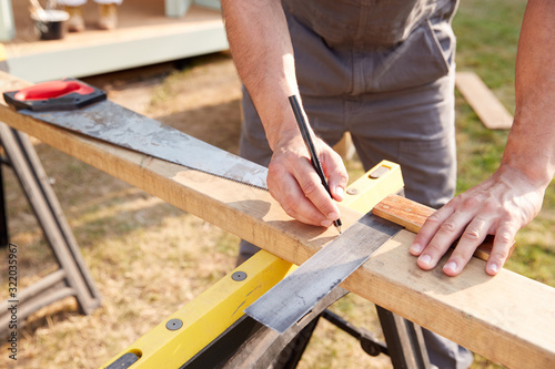Close Up Male Carpenter Measuring Wood Using Set Square Outdoors Fototapeta