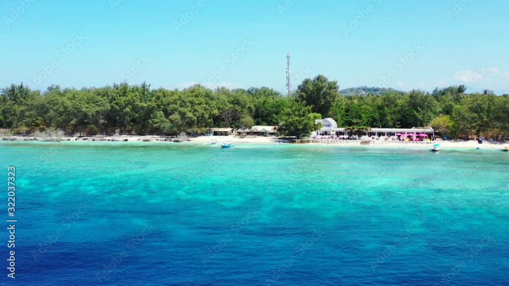 Beach bar surrounded by lush vegetation with boats floating on shallow blue turquoise lagoon on a summer vacation day in Philippines Beach bar surrounded by lush vegetation with boats floating on shallow blue turquoise lagoon on a summer vacation day in Philippines