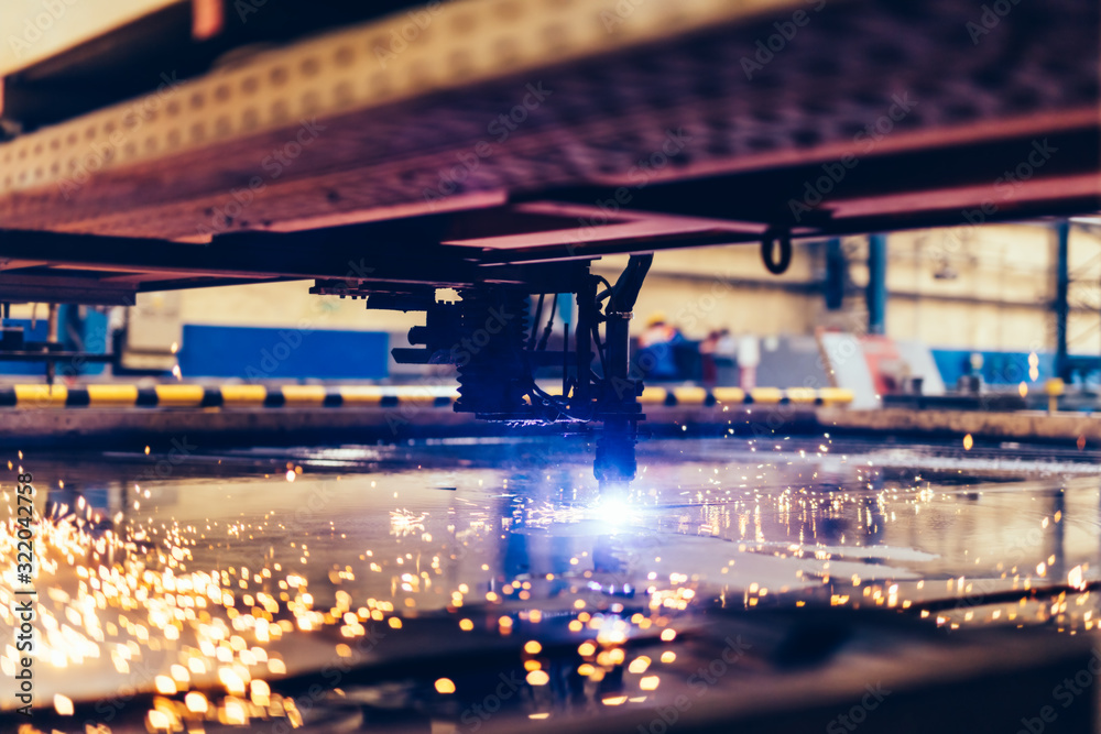 Flame cutting process with steel profiling machine in a factory Flame cutting process with steel profiling machine in a factory