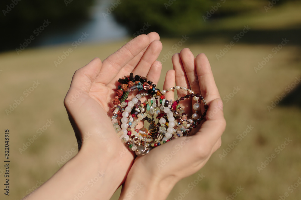 Stone bracelet handmade.Semi-precious stones bracelet. Bracelet on the hand close-up. Every day accessories. Selective focus.hands in the shape of heart Stone bracelet handmade.Semi-precious stones bracelet. Bracelet on the hand close-up. Every day accessories. Selective focus.hands in the shape of heart