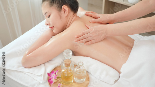 Young Asian woman getting Relaxing oil massage at beauty spa salon. Massage for health