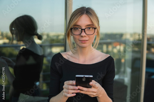 Young business woman uses phone. Good looking brunette female uses online banking on smart phone to transfer money from credit card. Girl using smart phone and chatting with business partners. Free Download Young business woman uses phone. Good looking brunette female uses online banking on smart phone to transfer money from credit card. Girl using smart phone and chatting with business partners. - GFXLoad