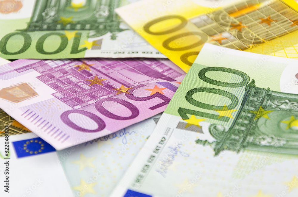 Currency of the European Union of different denominations on an orange background 2 Currency of the European Union of different denominations on an orange background 2