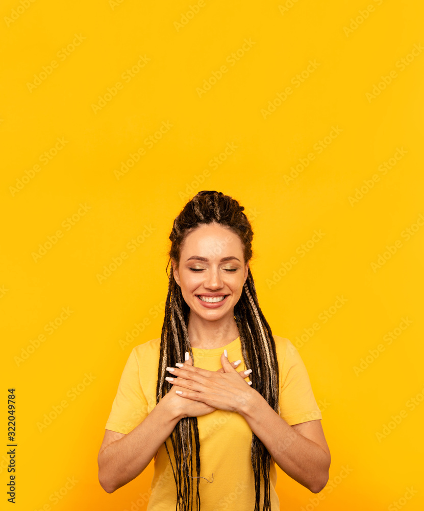 Glad pleased happy young woman in the yellow studio