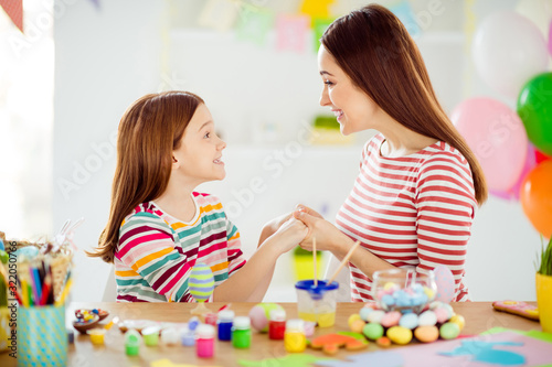 Close-up profile side view portrait of nice attractive lovely gentle sweet cheerful cheery girls small little daughter making handicraft spending day holding hands in white light interior room house