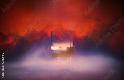 Cocktail in a glass rox glass with ice smoke burns on Lush Lava background. Close up photo