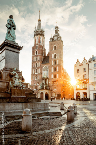 Adam Mickiewicz monument and St. Mary's Basilica on Main Square in Krakow, Poland photo