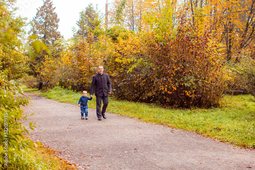 Dad and son in the autumn park © oksix