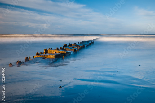 Long exposure shot of the sea and a pier in a sunset, Baltic Sea, Poland