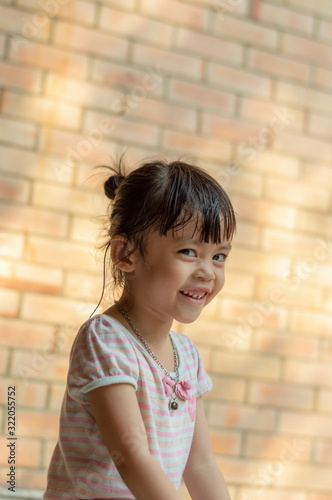 Closeup portrait of Hearing impaired asian little girl smile.
