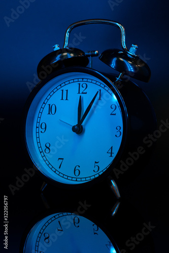 Fototapeta Naklejka Na Ścianę i Meble -  Alarm clock close up on black background