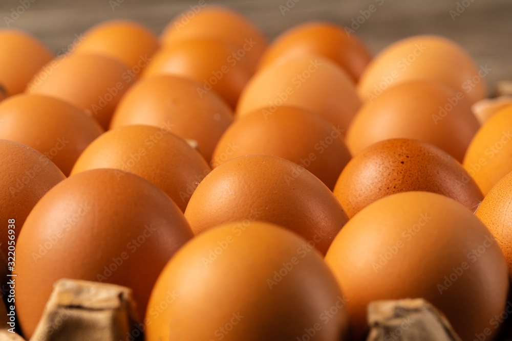 Chicken eggs in box on wooden table. Chicken eggs in box on wooden table.