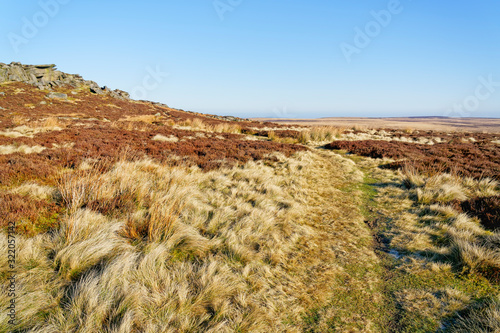 A feint footpath through the grass and heather runs along side Stanage Edge photo