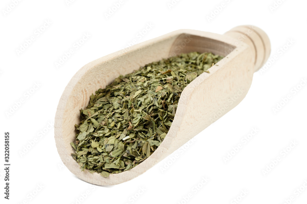 dried lovage herb in wooden scoop isolated on white background. spices and food ingredients dried lovage herb in wooden scoop isolated on white background. spices and food ingredients