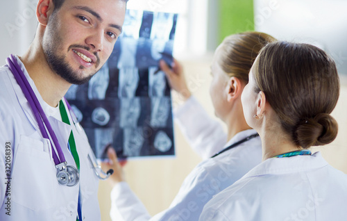 Medical doctors analysing x-ray photography in hospital