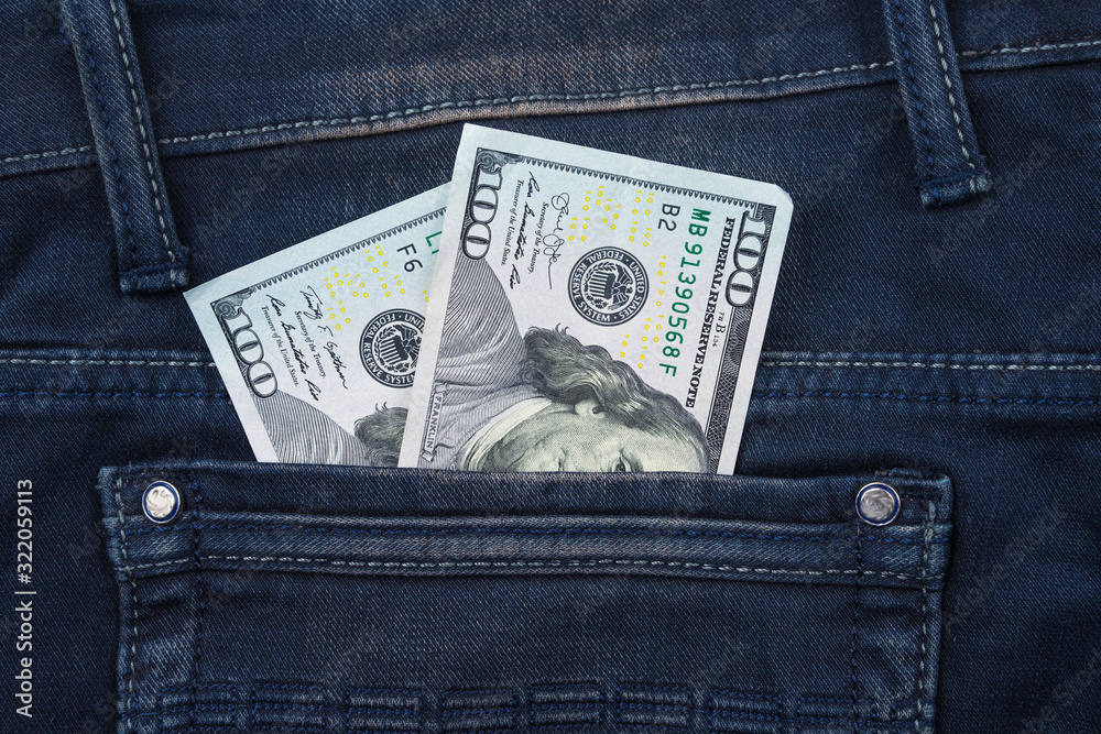 One hundred dollar banknote money in pocket jeans pants background texture. 100 dollar bill close up One hundred dollar banknote money in pocket jeans pants background texture. 100 dollar bill close up