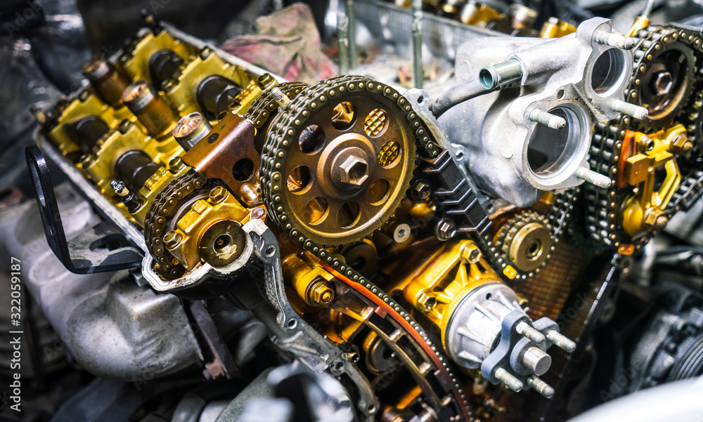 Car repair: type of open engine with drive chains and a large number of pulleys and parts.