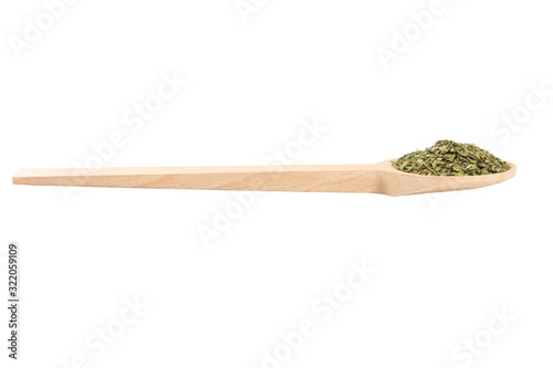 dried lovage herb in wooden spoon isolated on white background. spices and food ingredients. spices and food ingredients